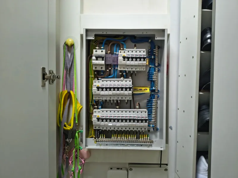 Electrician upgrading a distribution board with MCB and RCCB in an HDB flat