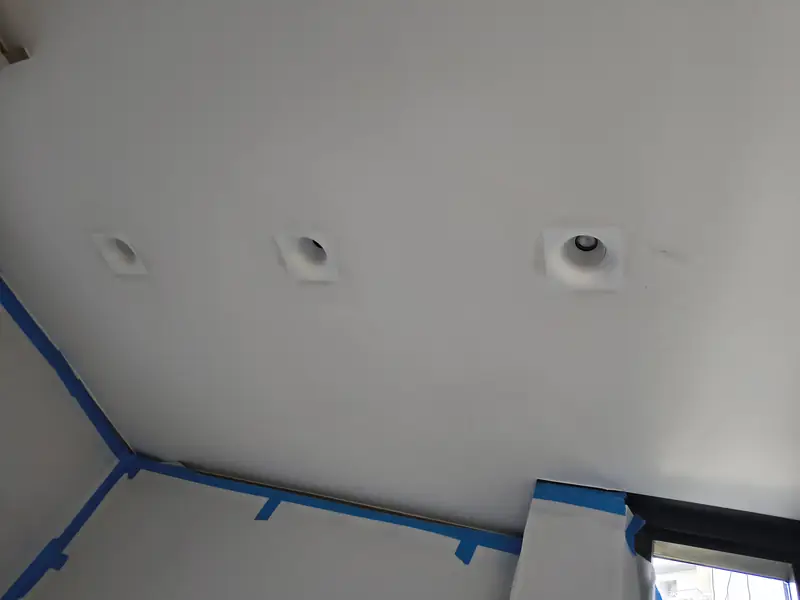 Recessed downlights installed in a plaster ceiling during renovation